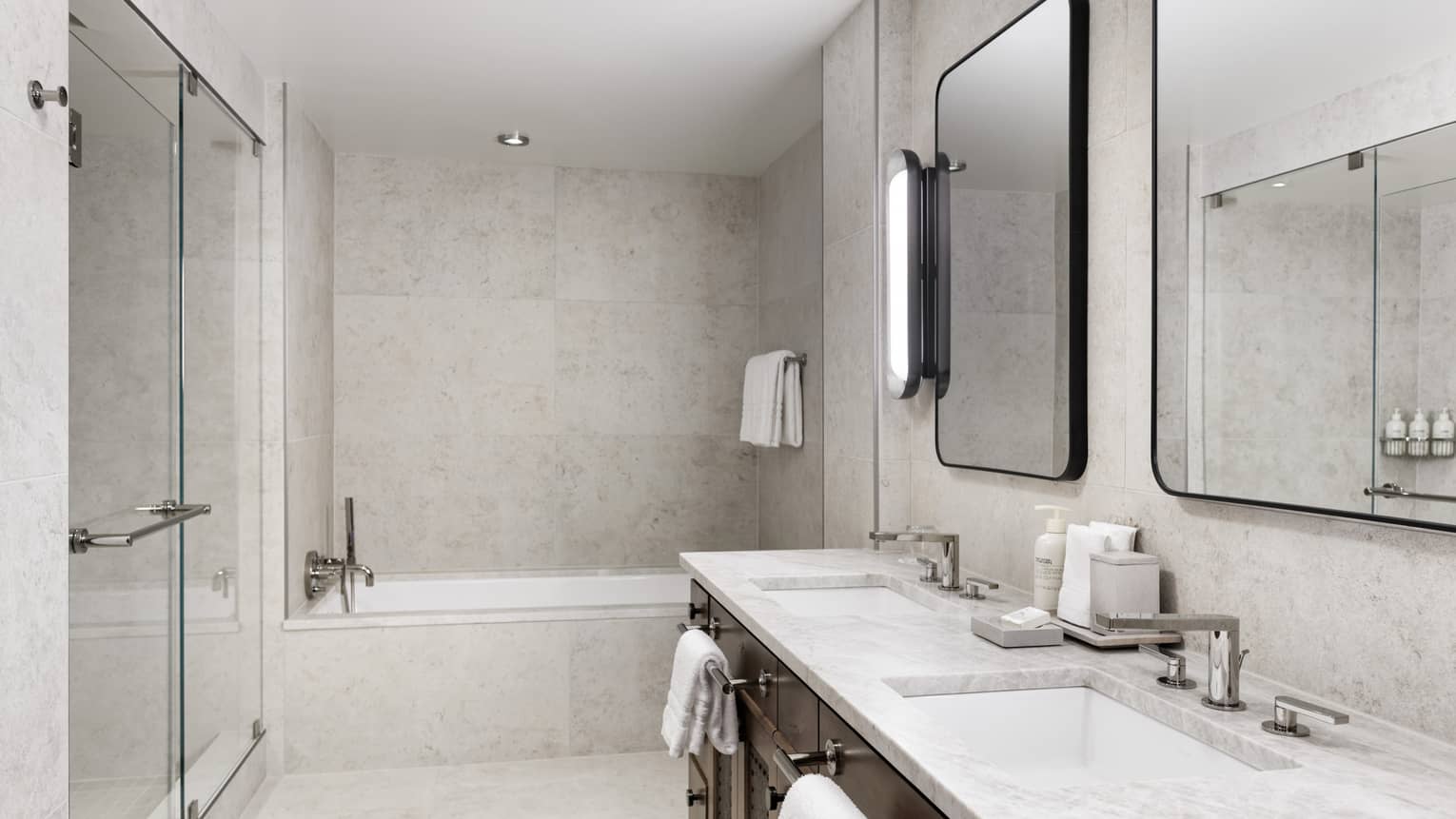 Modern bathroom with a glass-enclosed shower, soaking tub, double vanity with marble countertop, and large framed mirrors