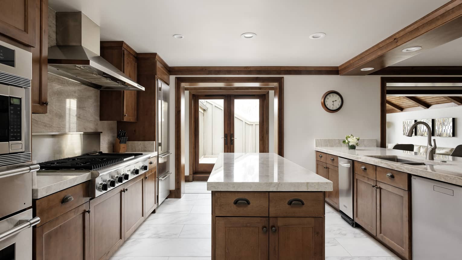 Modern kitchen of a private residence, with an island and dark wood cabinets
