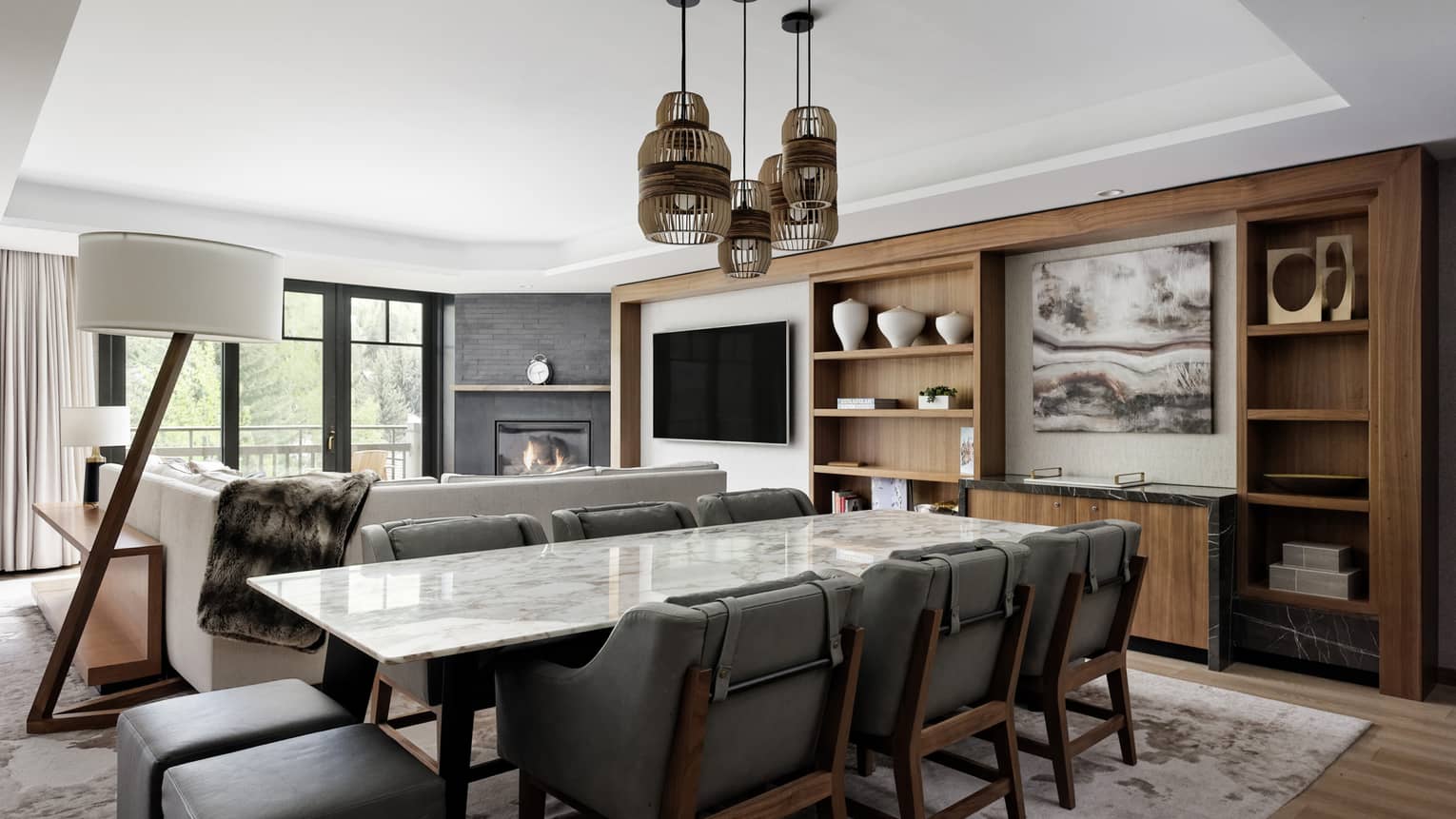 Living and dining room, featuring a large marble table and six leather chairs, in a luxury private residence at Four Seasons Resort and Residences Vail