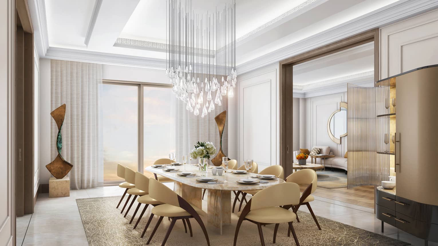 Luxurious dining room with a marble table, cream chairs, a sculptural chandelier and a view into a stylish adjoining lounge.