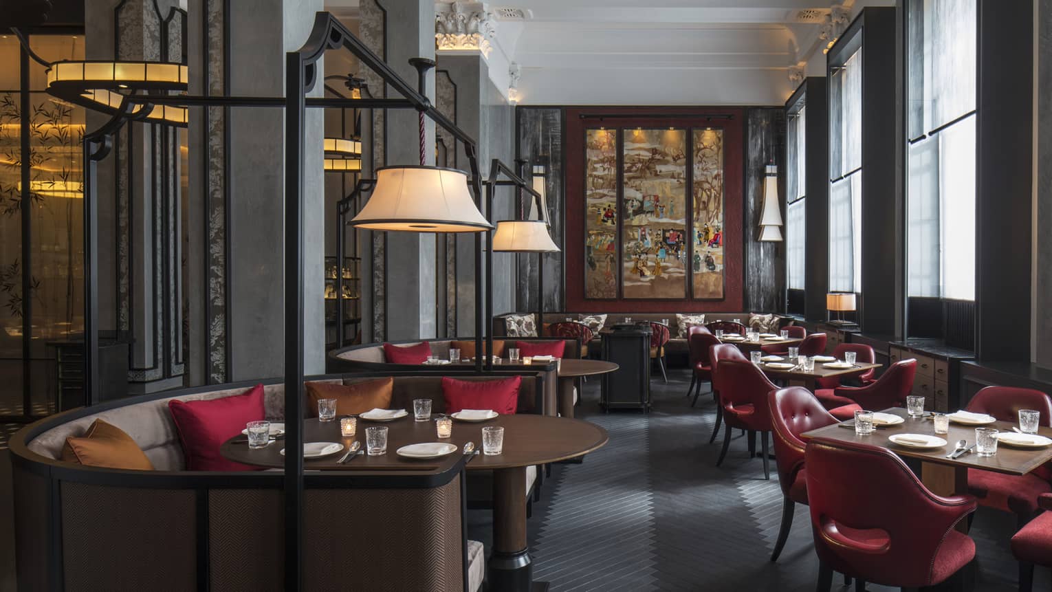 Wide view of Mei Ume dining room with brown tables, red chairs and red and brown accent pillows