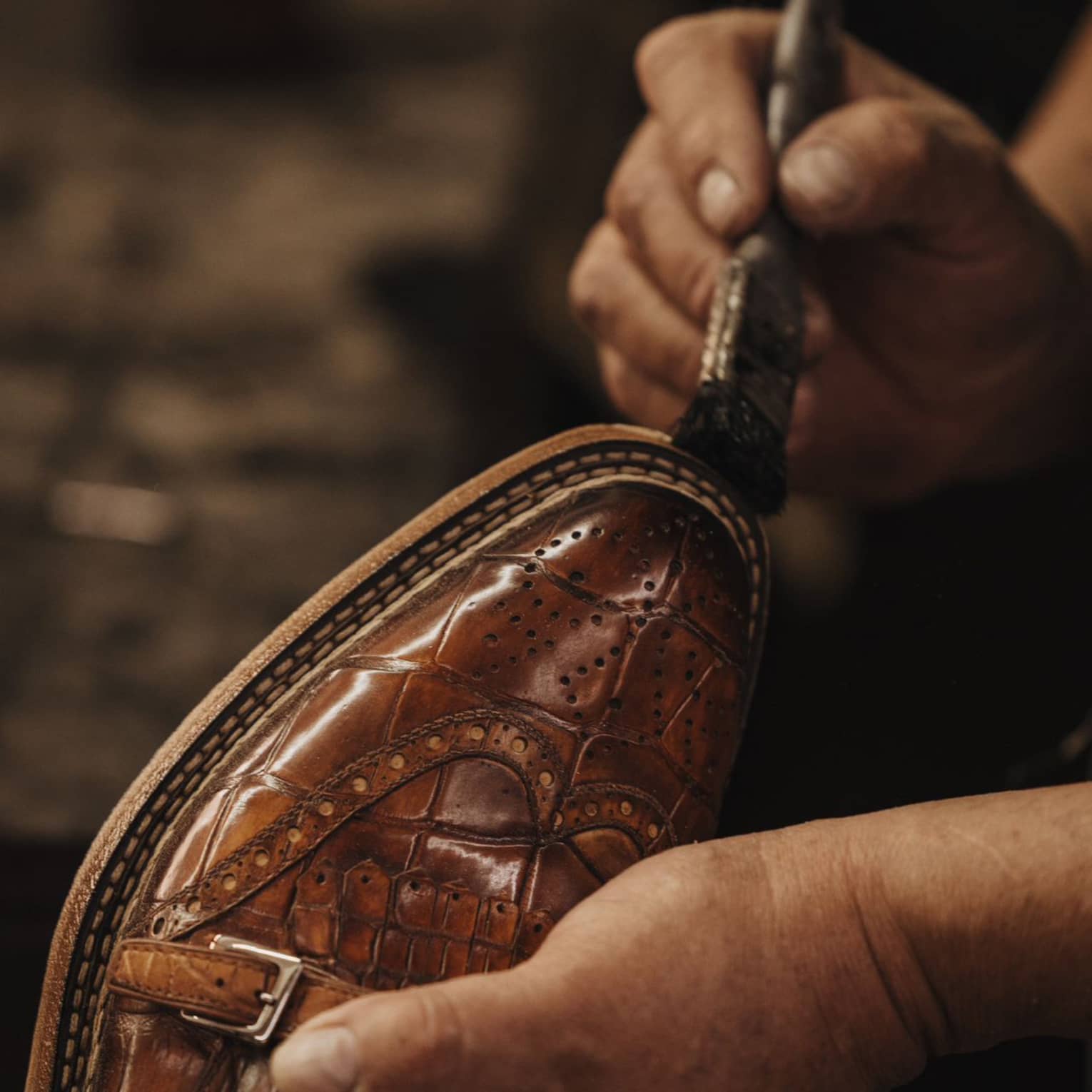 Paintbrush on brown leather shoe.