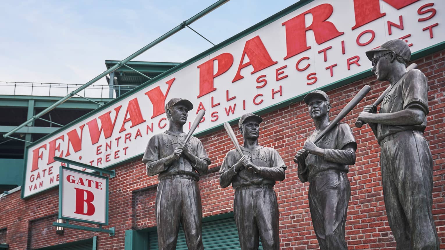 In front of Fenway Park’s Gate 5 is a bronze statue, called The Teammates, of four former Red Sox players in their uniforms.
