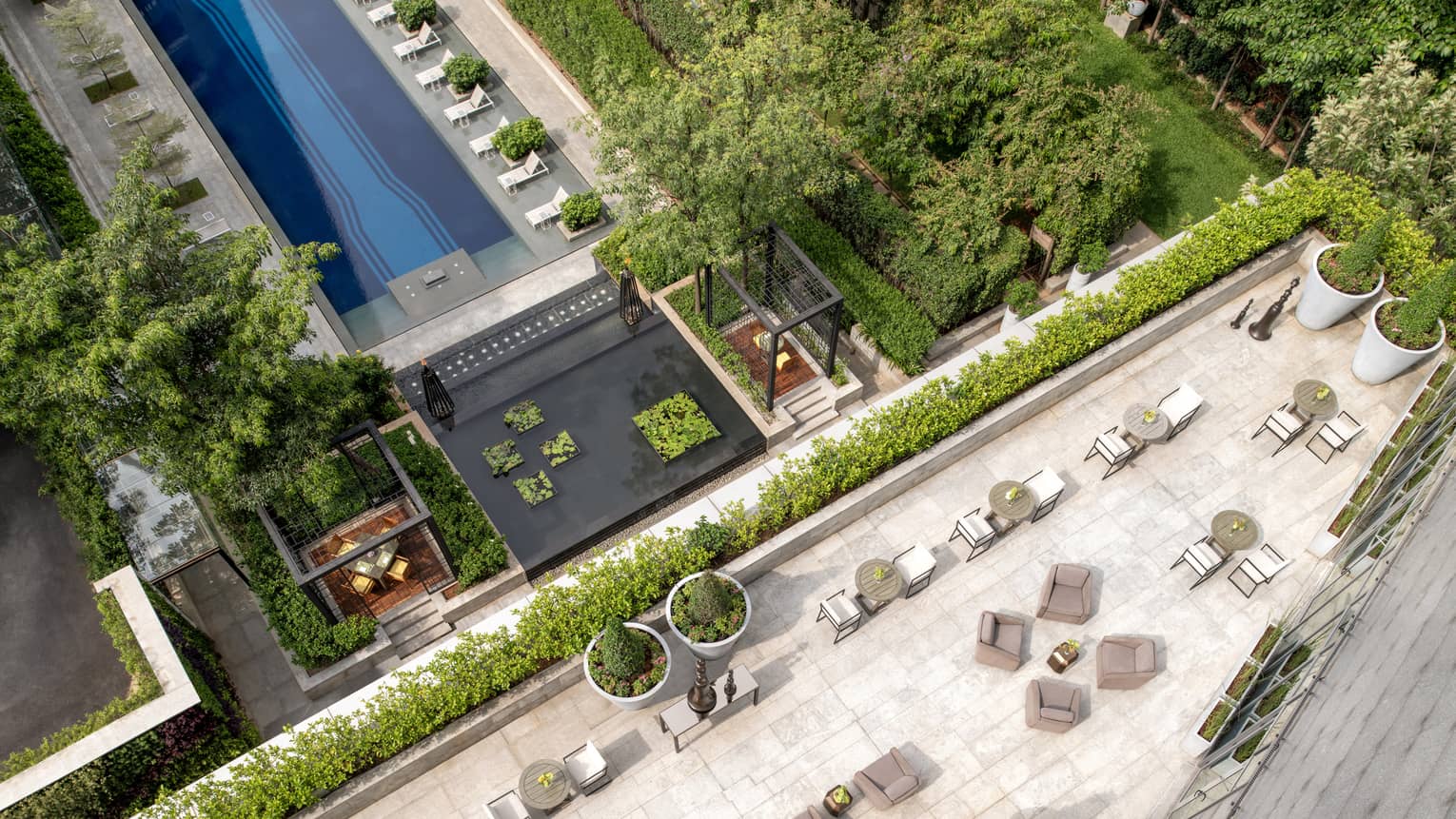 Aerial view of outdoor terrace with tables and chairs overlooking pool below