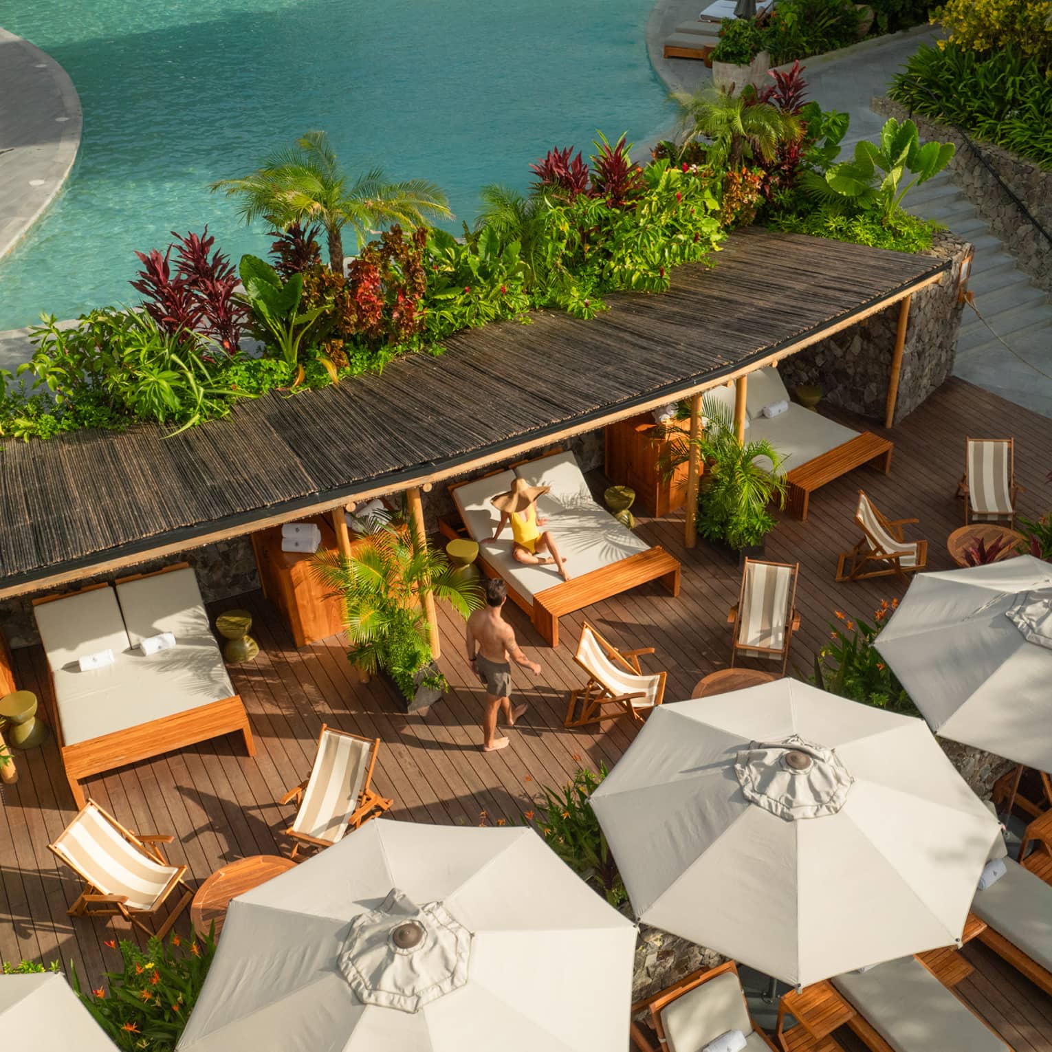 Aerial view of poolside cabanas and daybeds