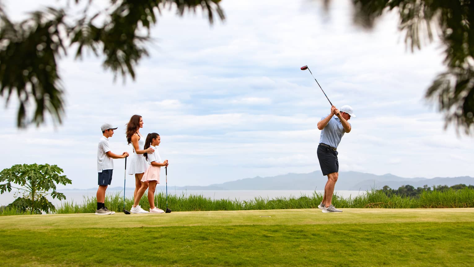 Family of four plays golf