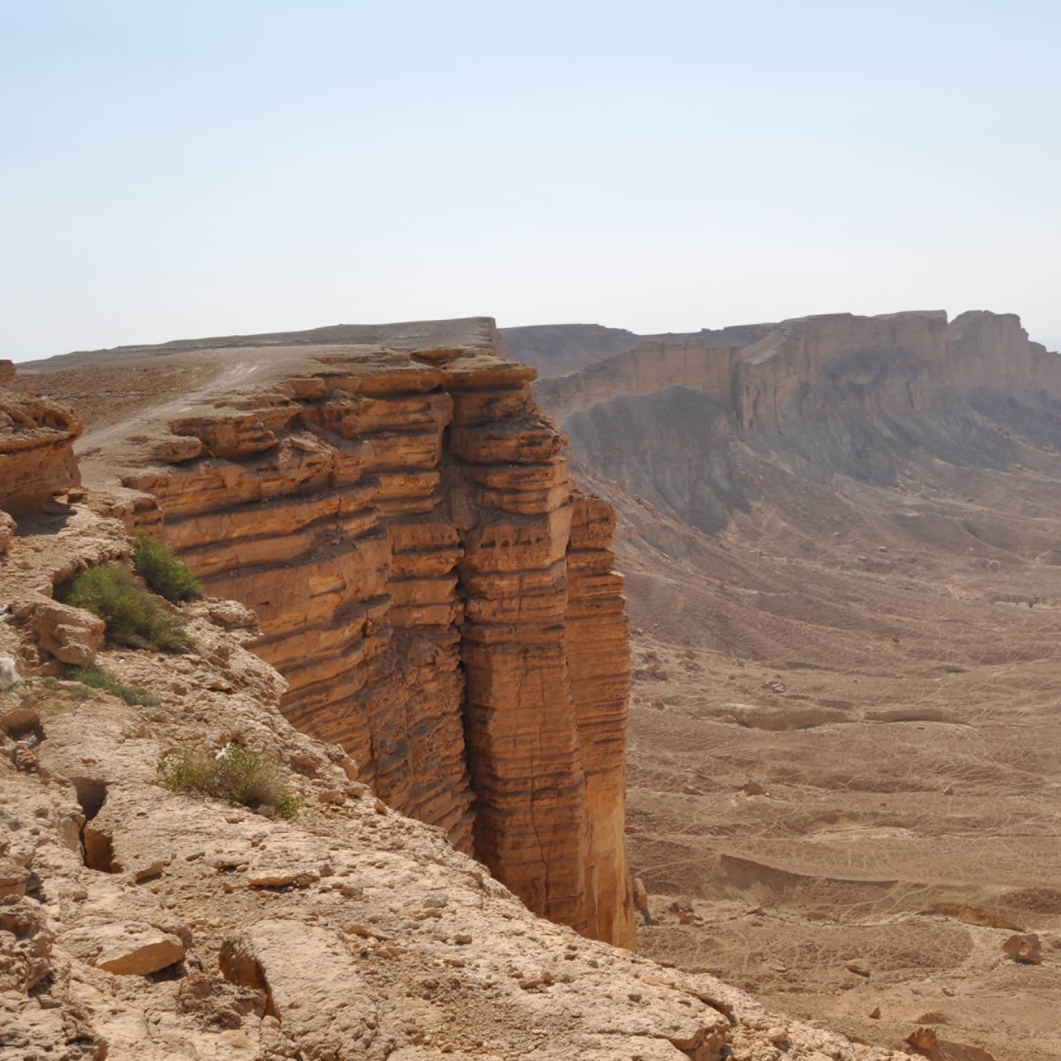 A rocky cliff overlooking a canyon