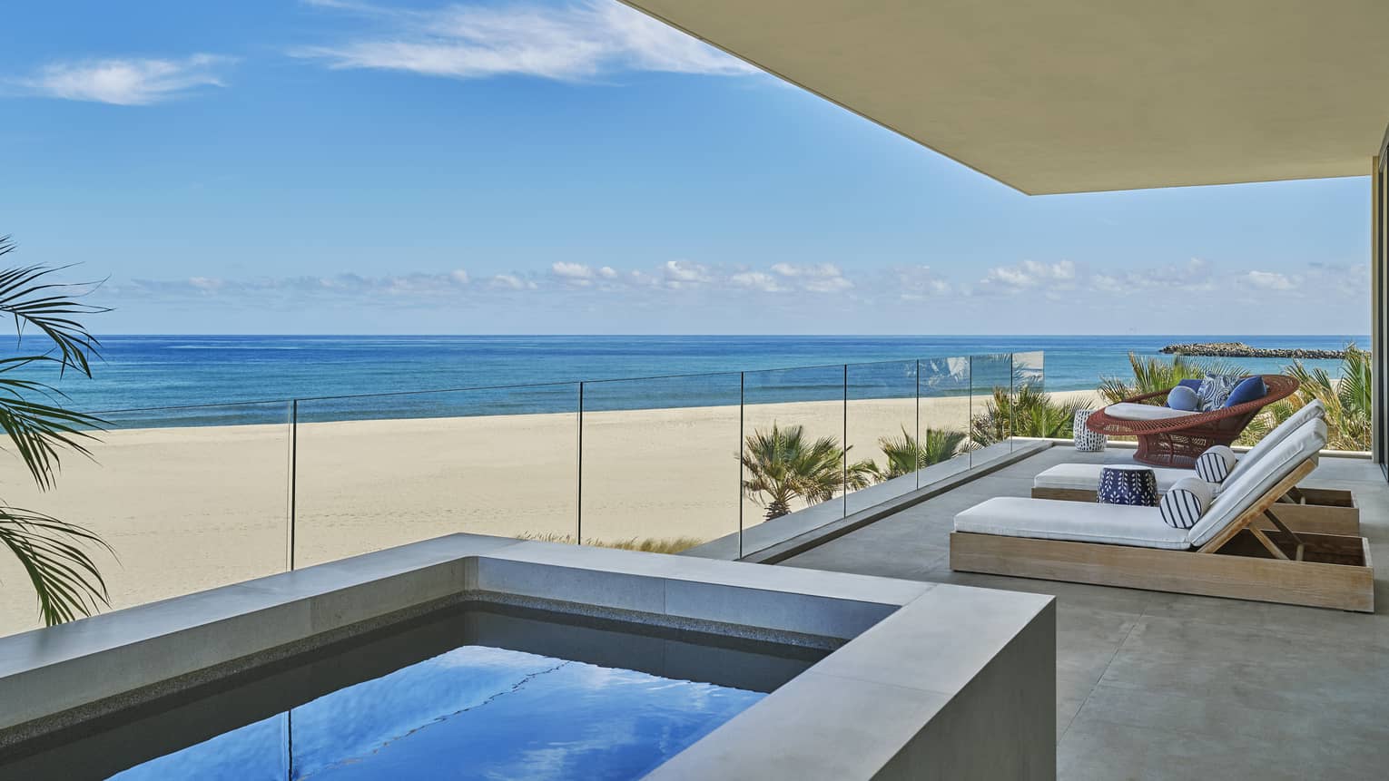 Private luxury villa terrace with glass balcony and plunge tub, looking out to the sea and beach, at Four Seasons Resort and Residences Los Cabos