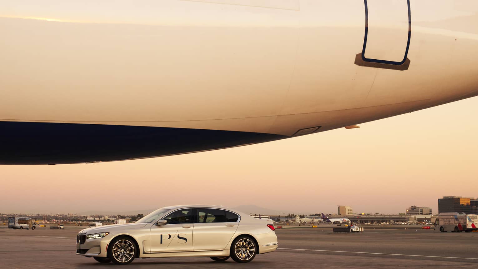 PS private car waits outside next to large aircraft