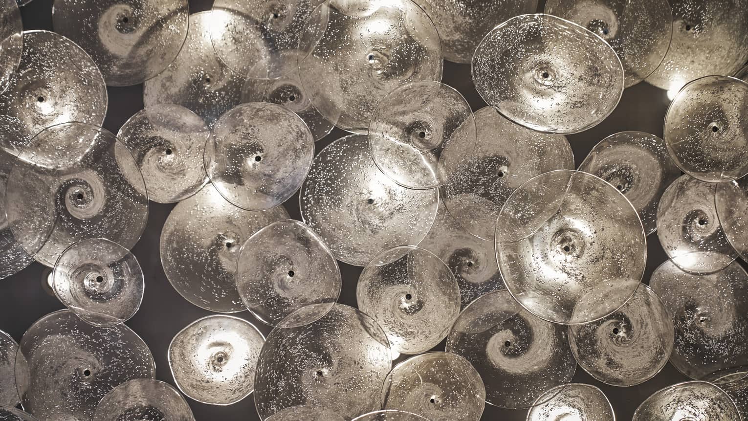 Glass sculptures, clear discs with swirls