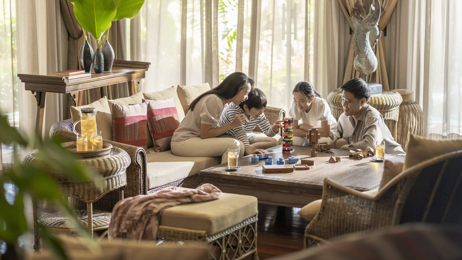 Family of four plays games in the living area of their One-Bedroom Residence