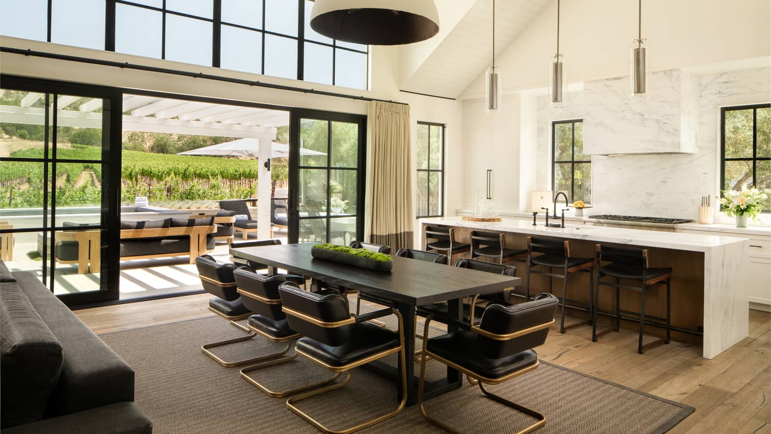 High-ceilinged kitchen and dining room of farmhouse-chic residence