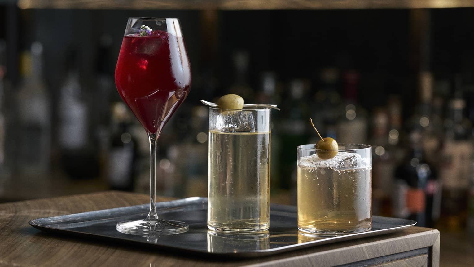 Three different cocktails on a bar tray