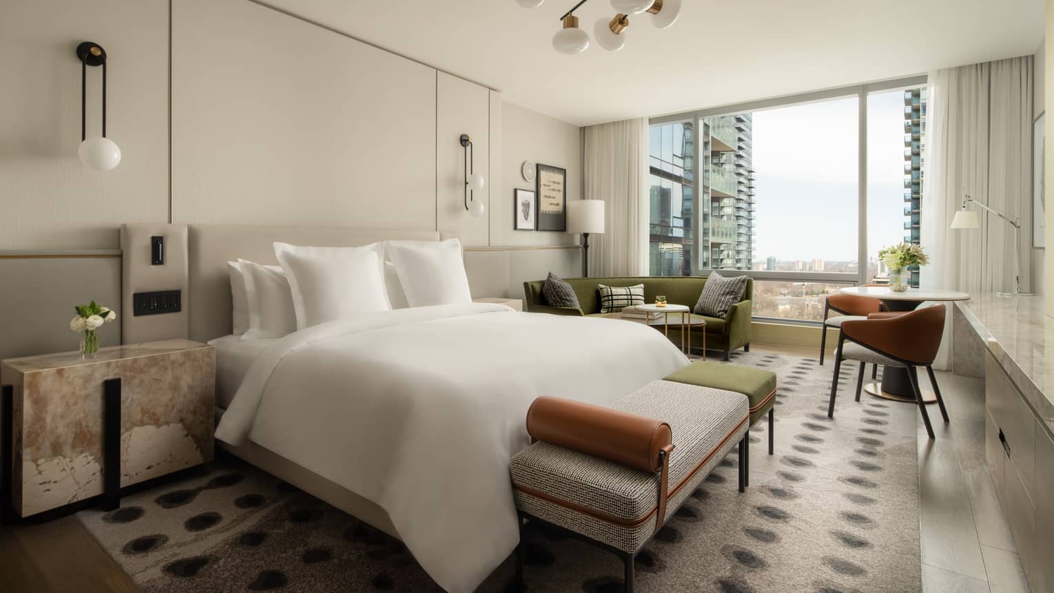 Five-star hotel room with a king-size bed, stylish furnishings, and floor-to-ceiling windows overlooking the cityscape