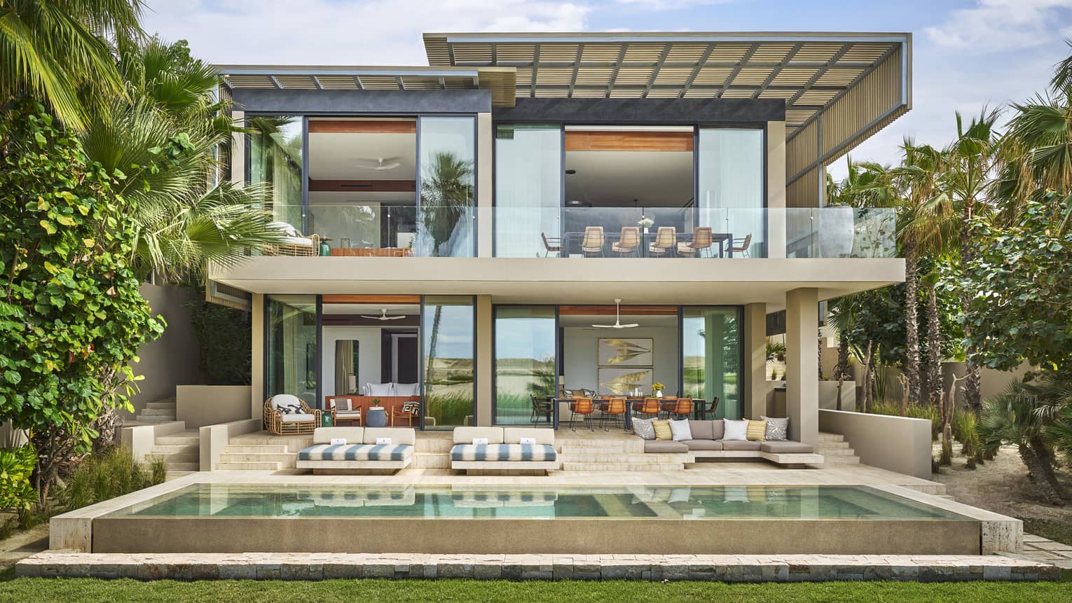 Exterior of the contemporary two-storey luxury Five-Bedroom Oasis Villa with tall windows and private pool