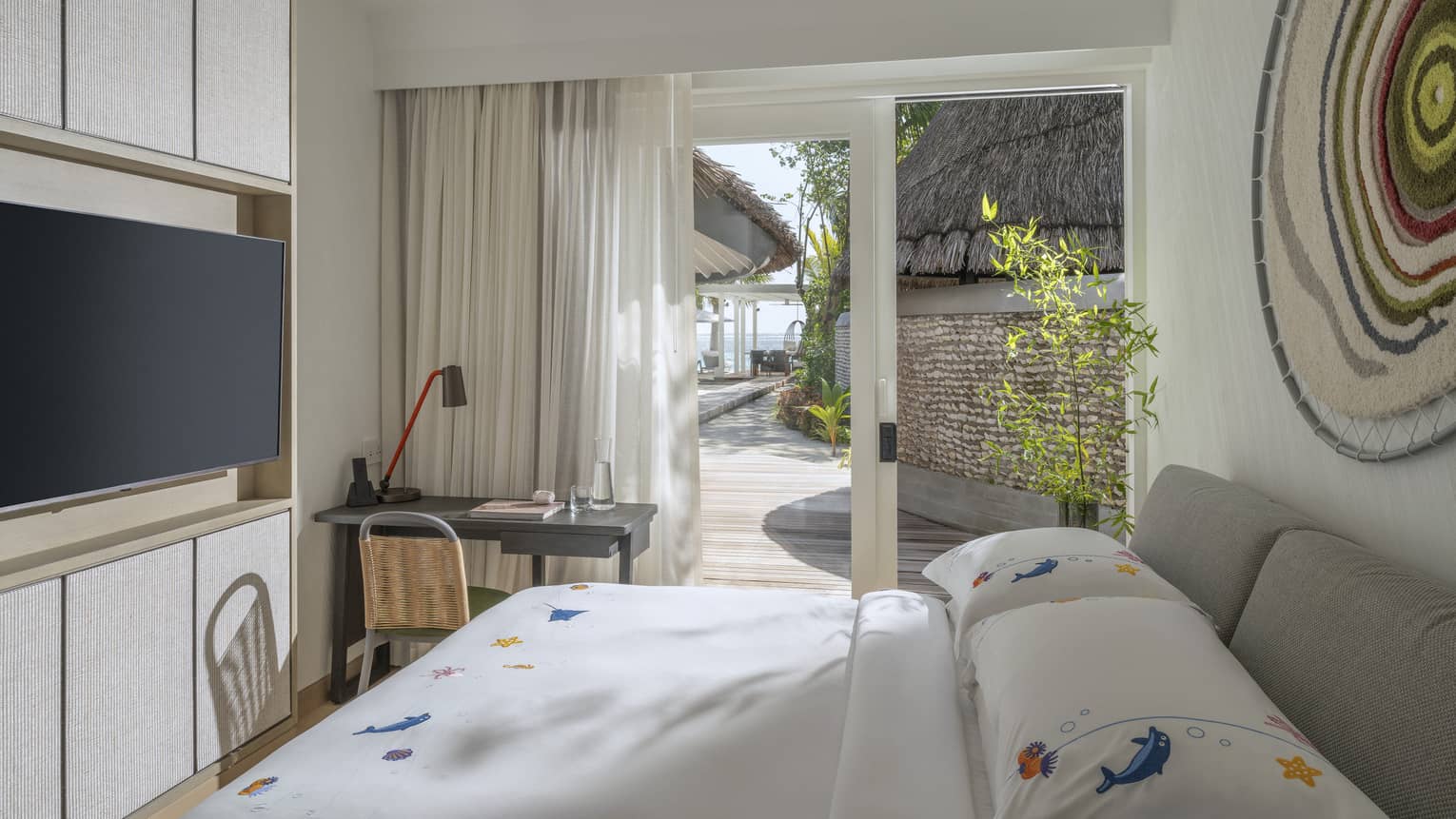 Kids bedroom with desk and TV at luxury tropical resort