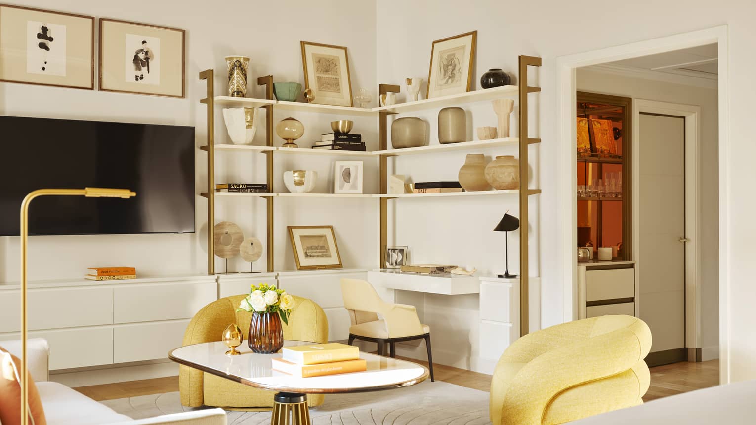 Modern luxury hotel suite living room with exposed shelving, yellow arm chairs and white sofa