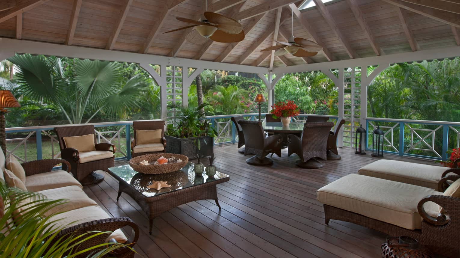Palm Grove Residence patio, wicker furniture under soaring wood ceilings, fans