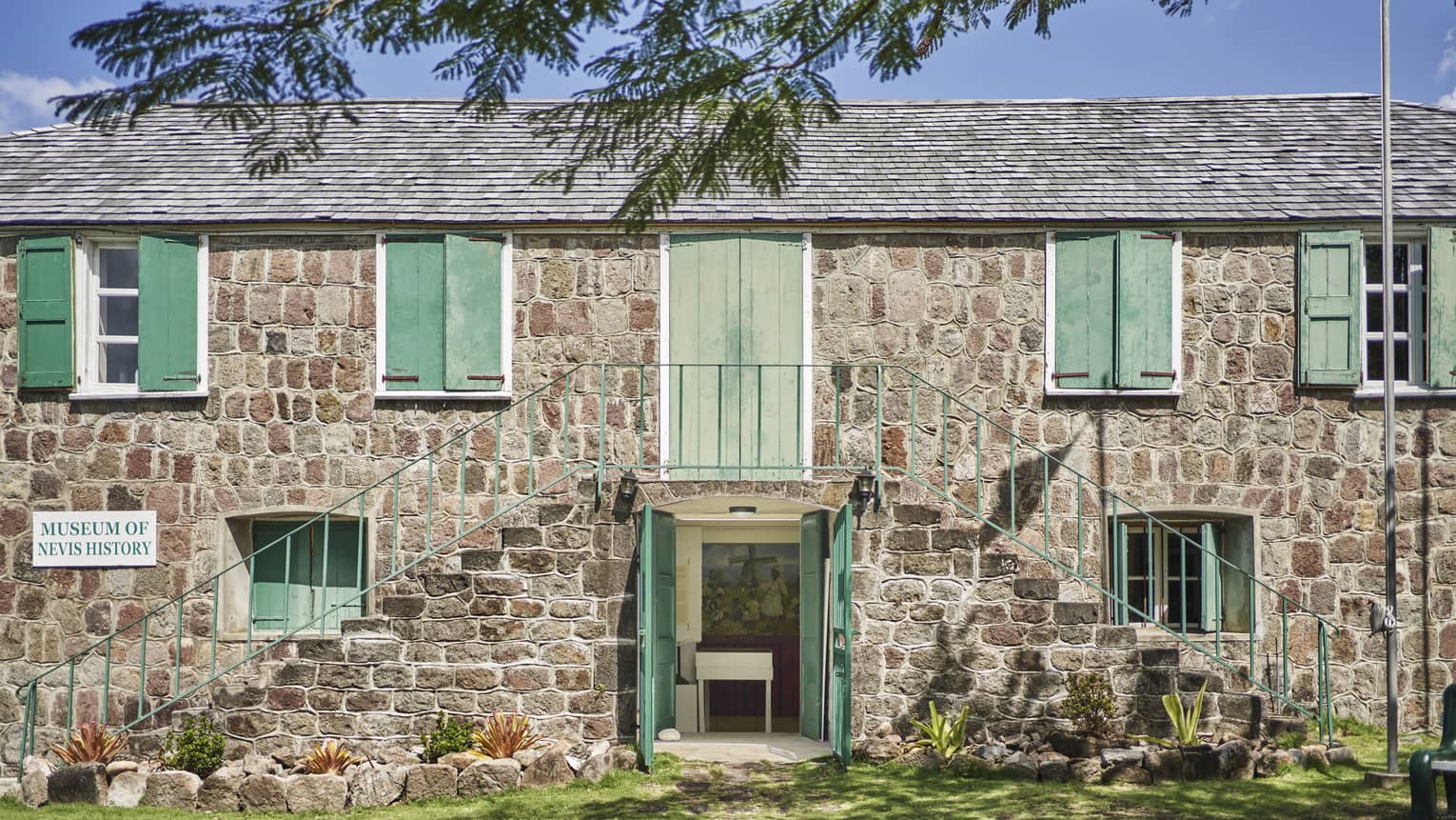 Hamilton House (museum building at Alexander Hamilton's birthplace on Nevis): gray stone building with green shutters