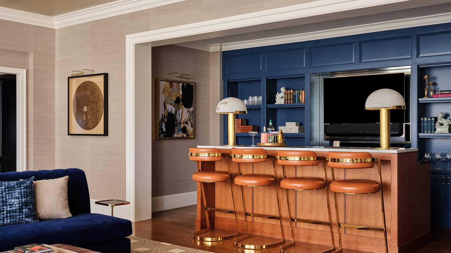 Bar counter and stylish blue wall of wooden built-in shelves, in the Royal Suite at Four Seasons Hotel Boston