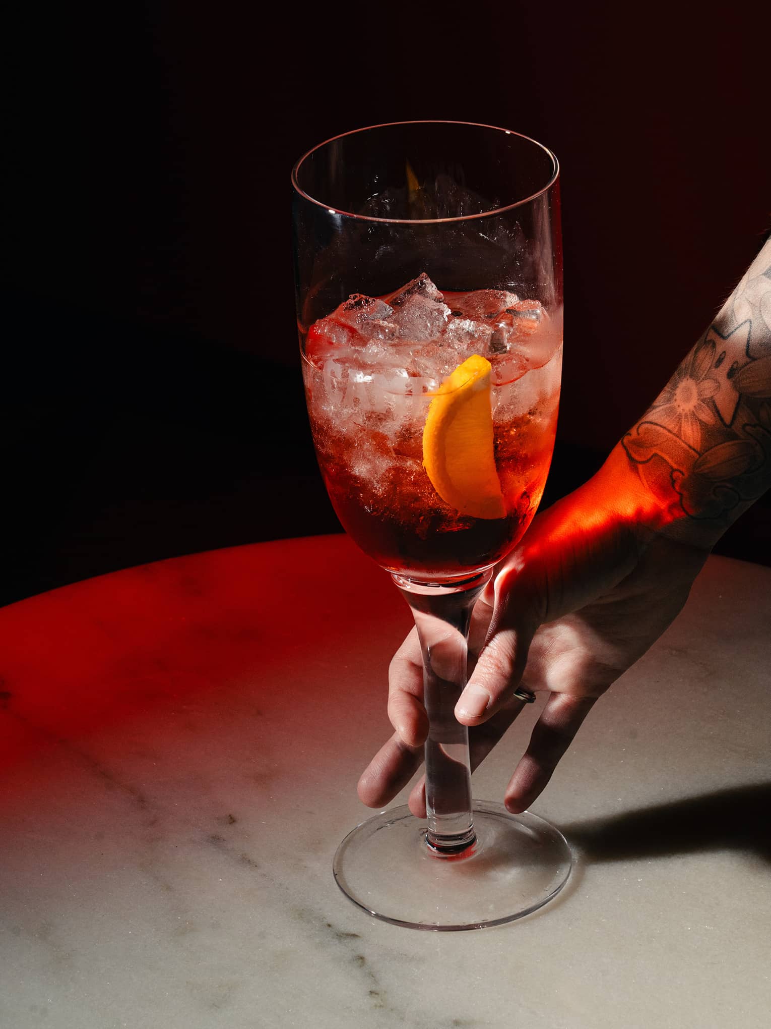 Sbagliato cocktail garnished with an orange slice