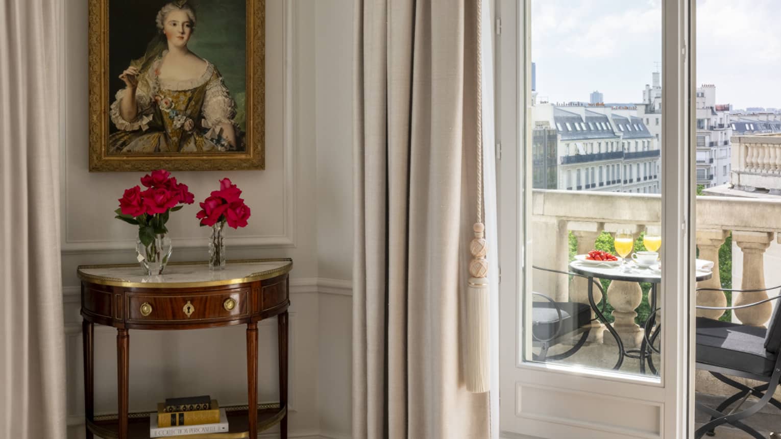 Grand Premier Suite balcony with table and two chairs, Paris city view, at Four Seasons Hotel George V, Paris