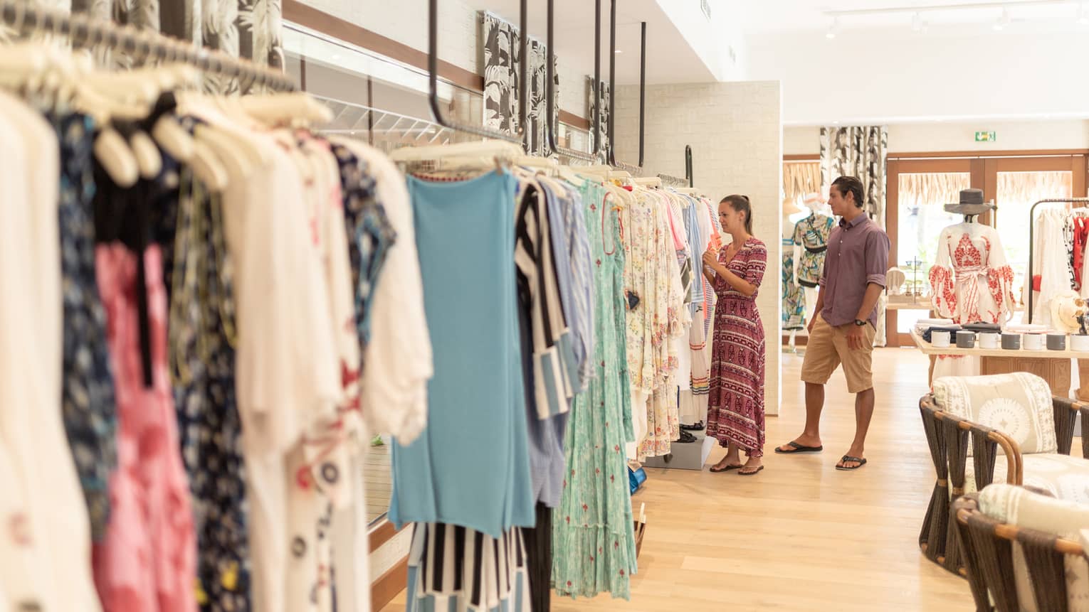 A man and woman shop in a clothing store