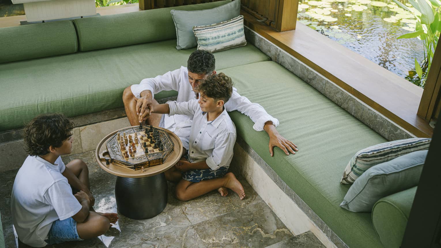 Father and kids playing a game in the residence
