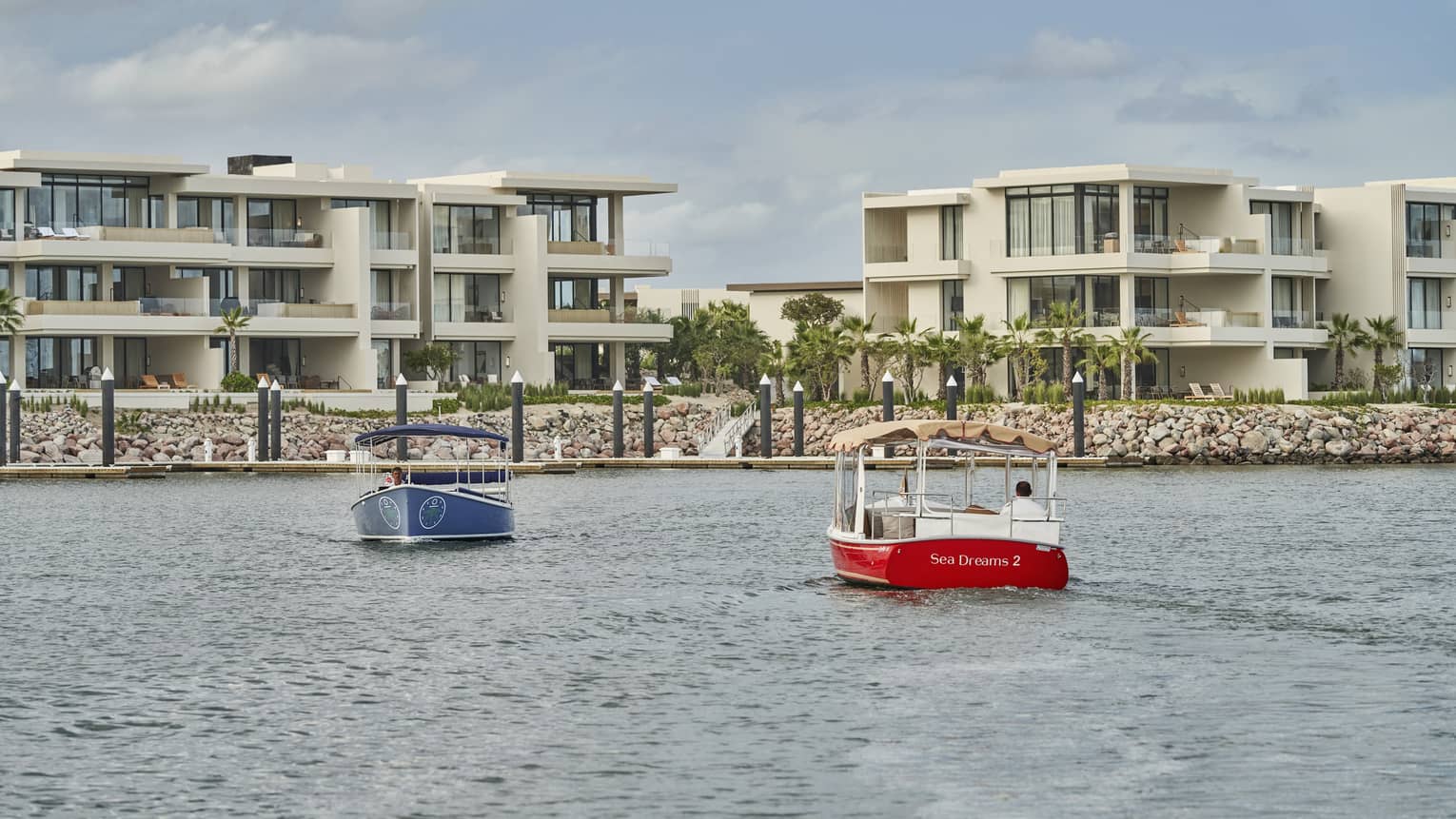 Two water taxis moving across water.