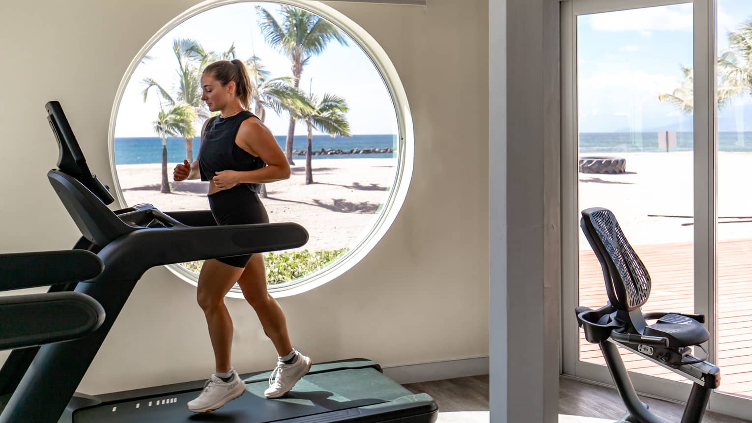 A person running on a treadmill in an indoor gym