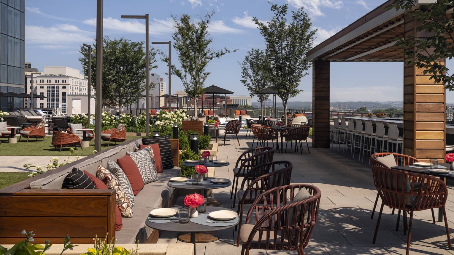 An outdoor seating area with sofas, chairs and plants.