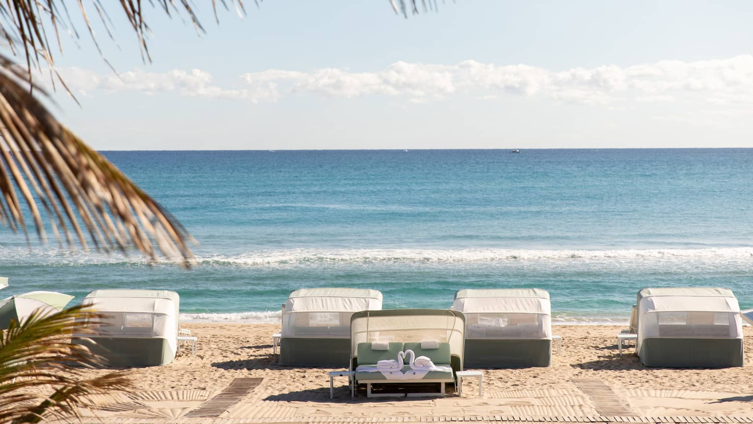 Five beachfront cabanas look out onto the ocean