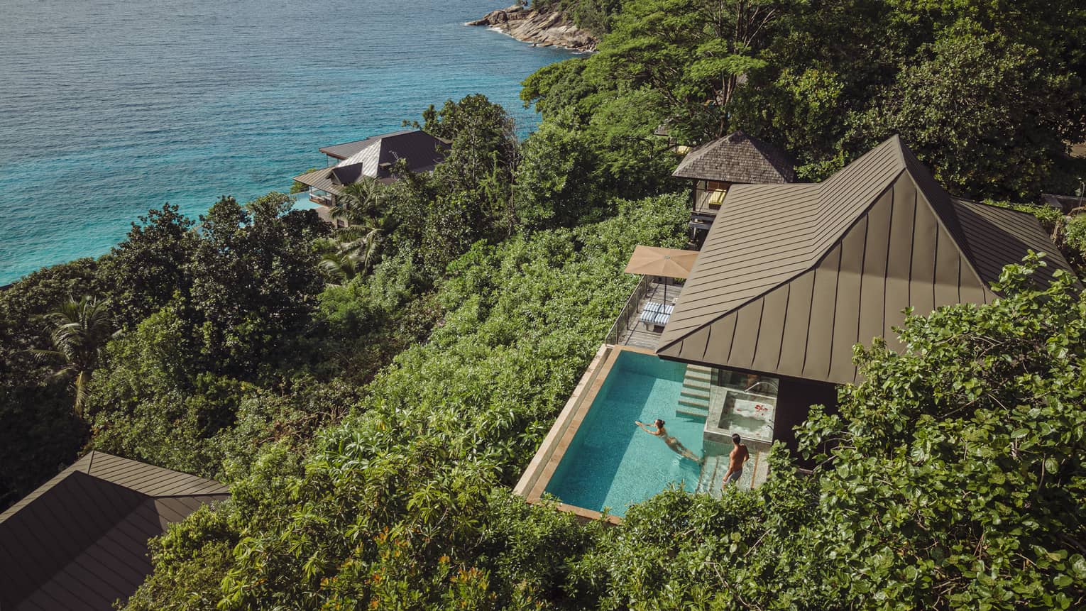 Aerial view of a Residence Villa at Four Seasons Resort Seychelles, overlooking turquoise ocean.
