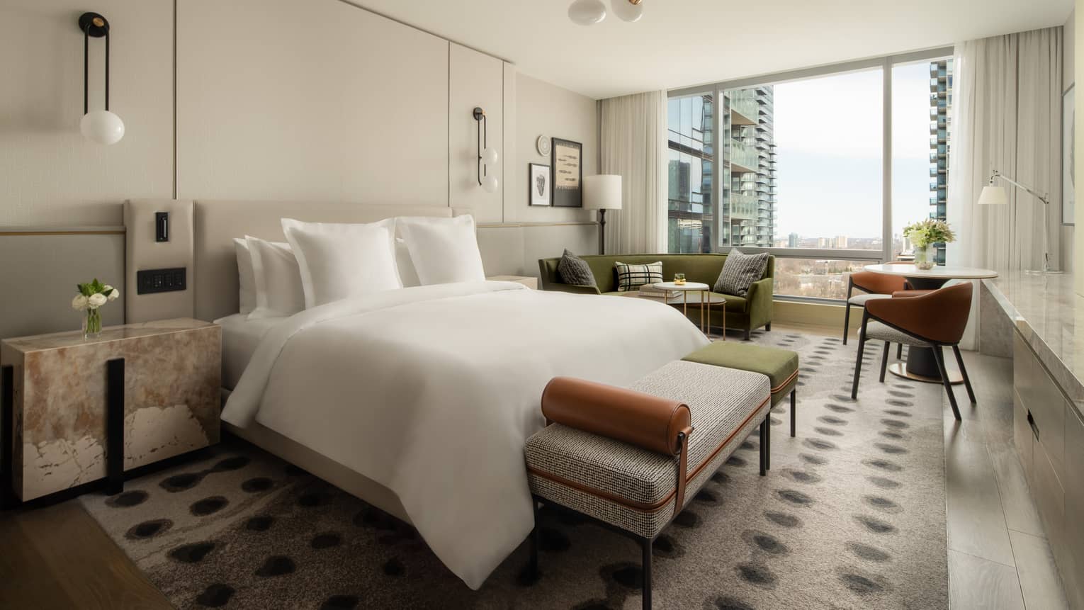 Five-star hotel room with a king-size bed, stylish furnishings, and floor-to-ceiling windows overlooking the cityscape
