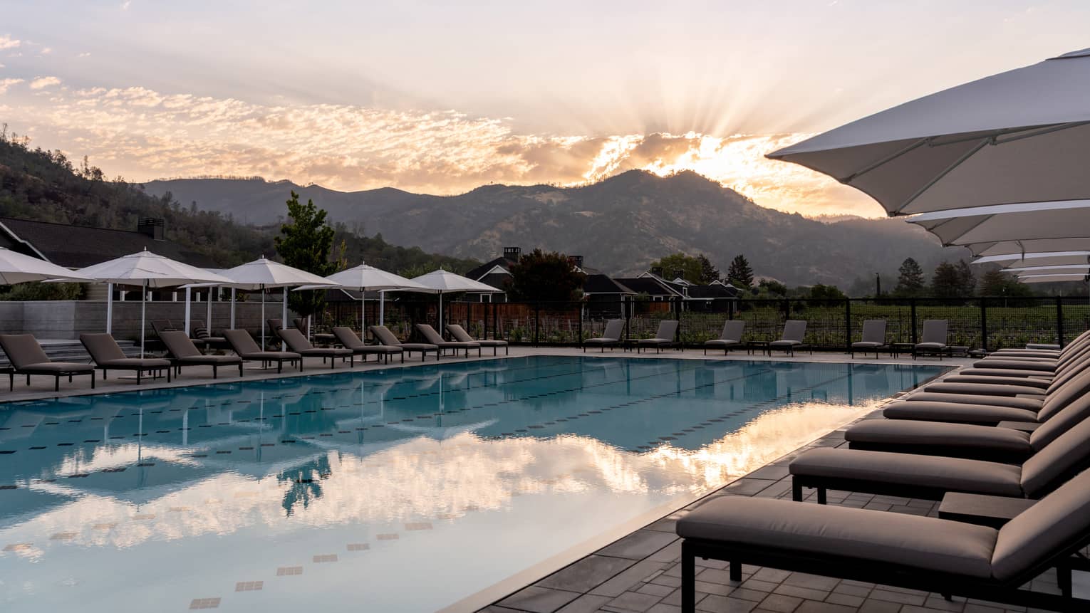 An outdoor pool with a mountain in the background.