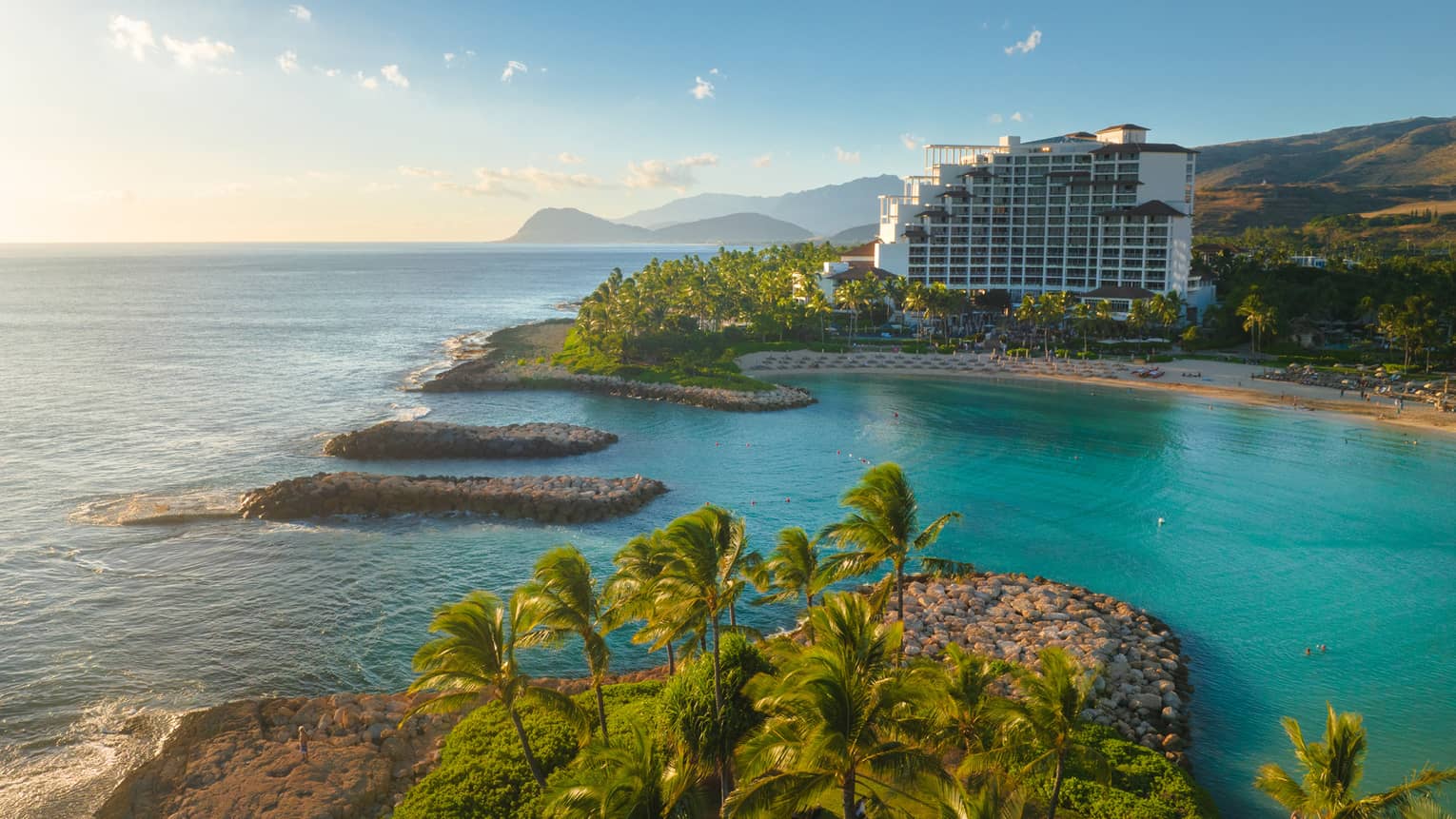 Resort building set on a turquoise lagoon on Hawaiian island
