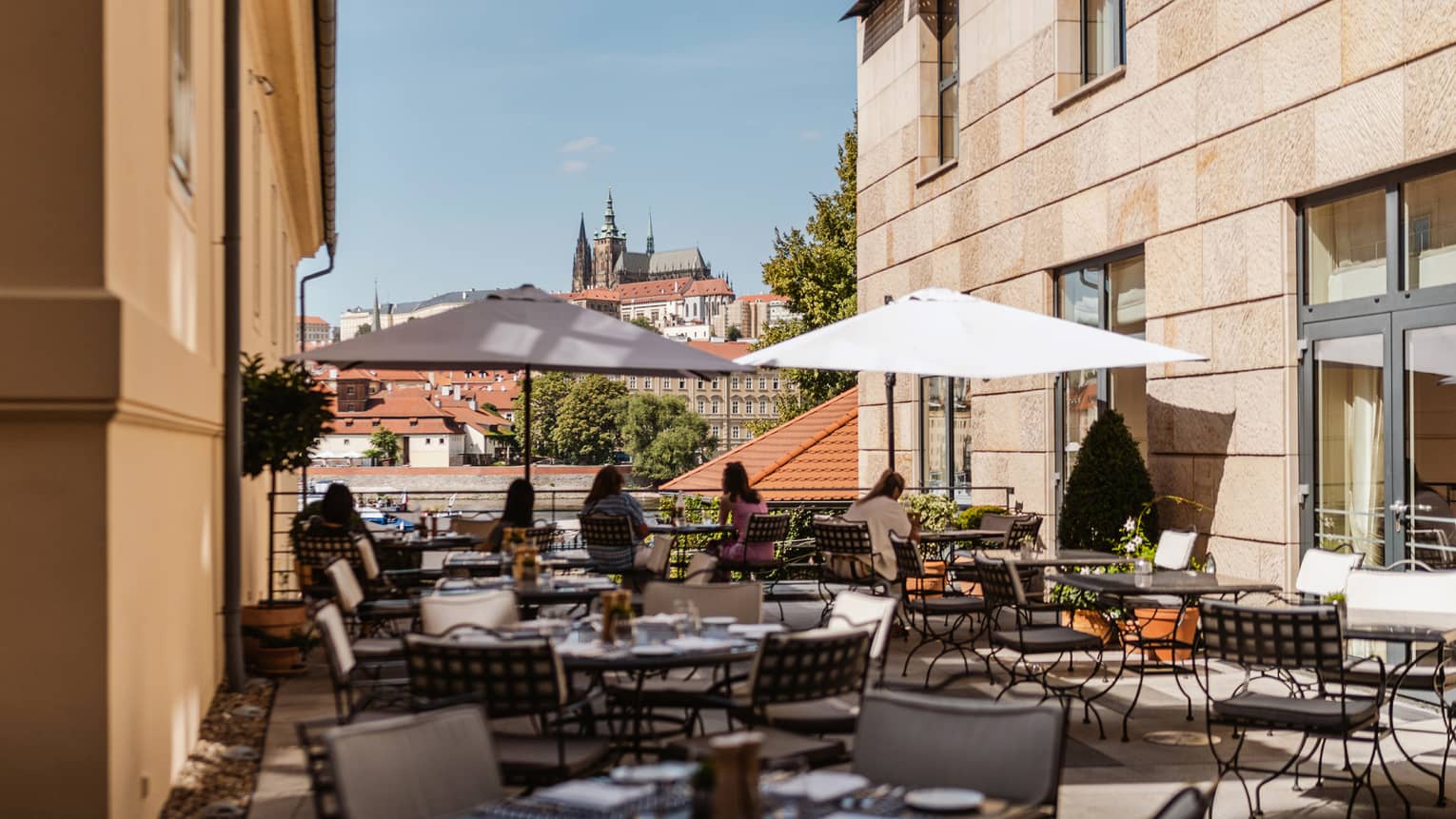 Rooftop terrace with wrought iron tables and market umbrellas