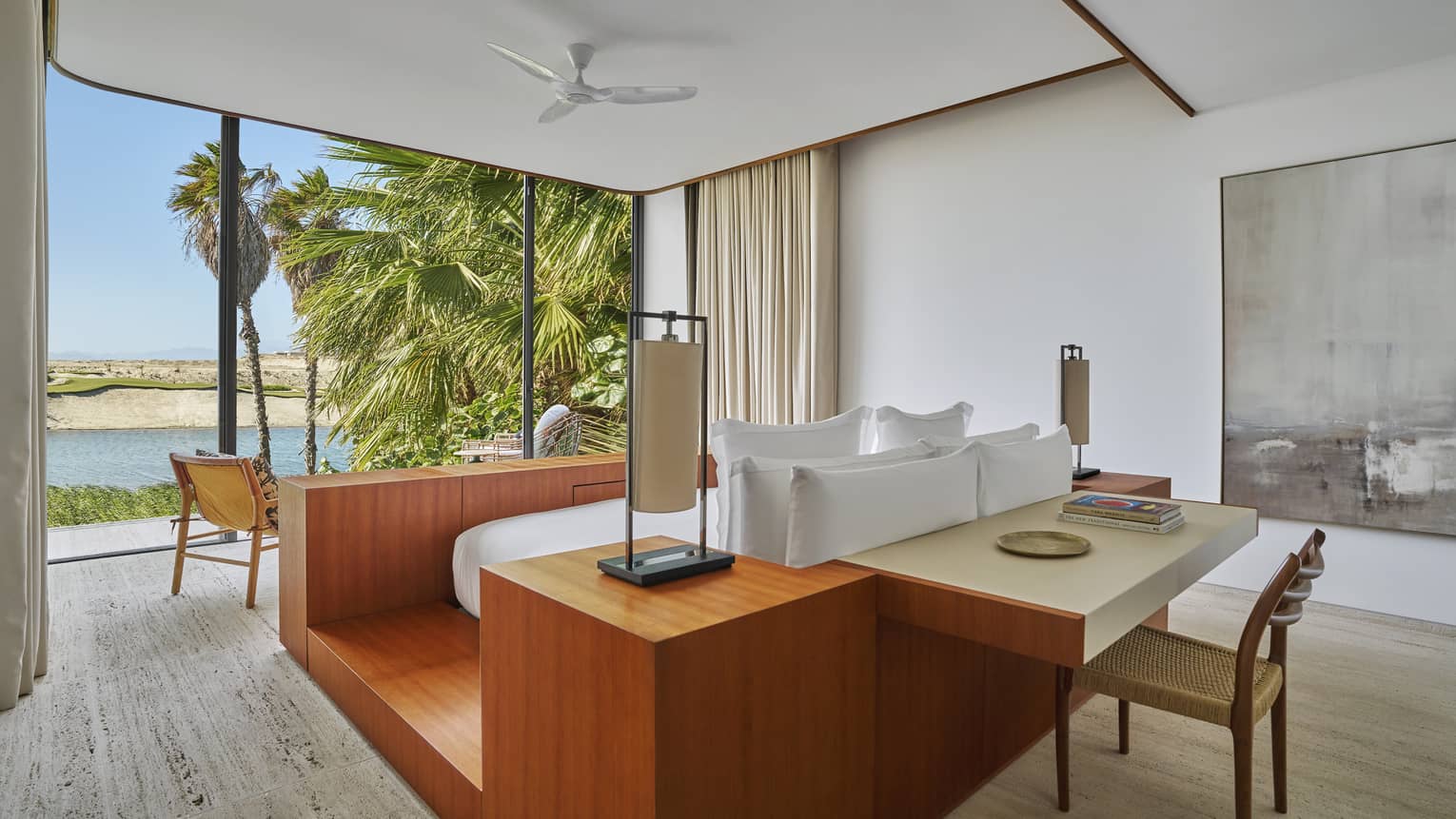 Luxury villa bedroom king bed, set on a contemporary wooden platform, at Four Seasons Resort and Residences Los Cabos