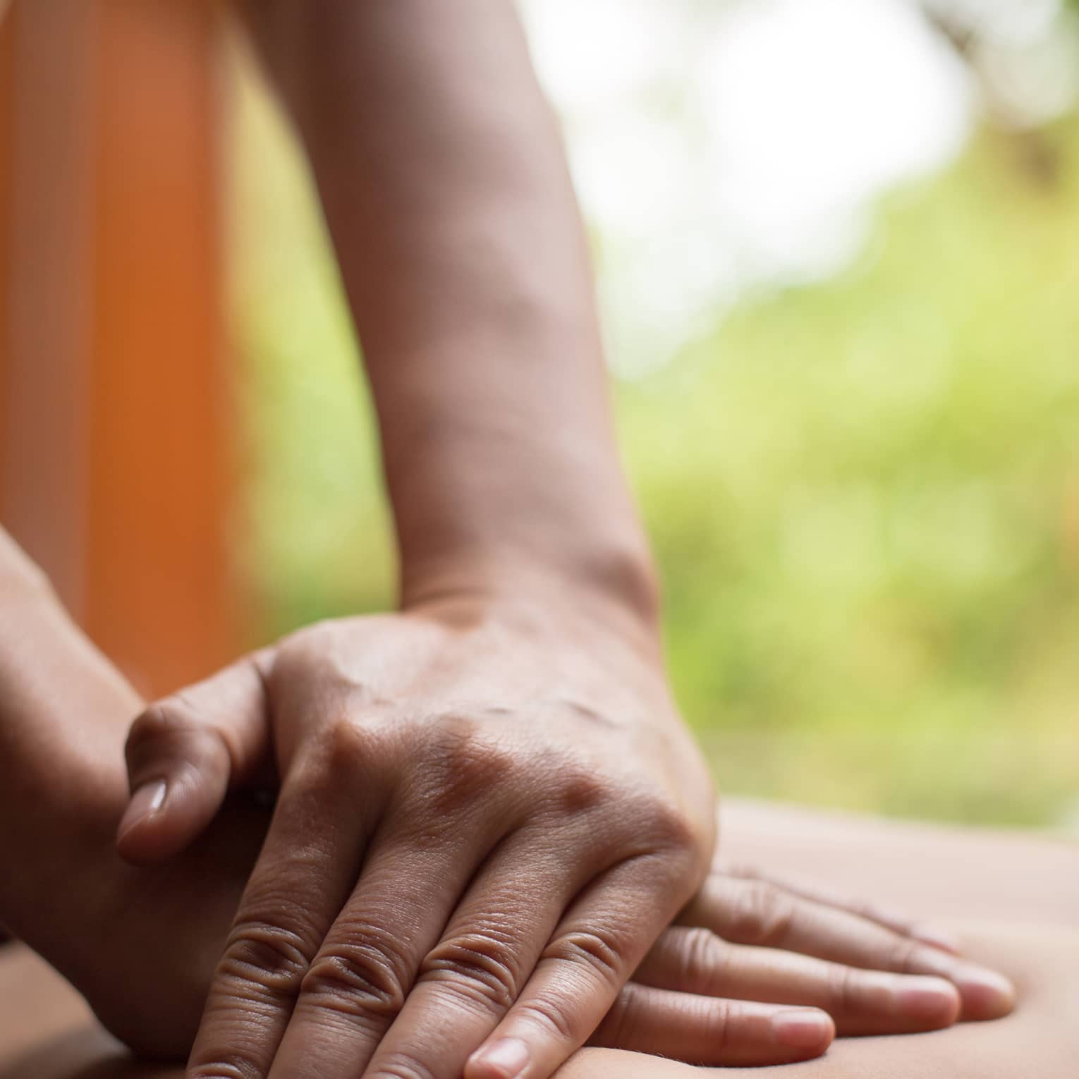 Close up of hands massaging a back