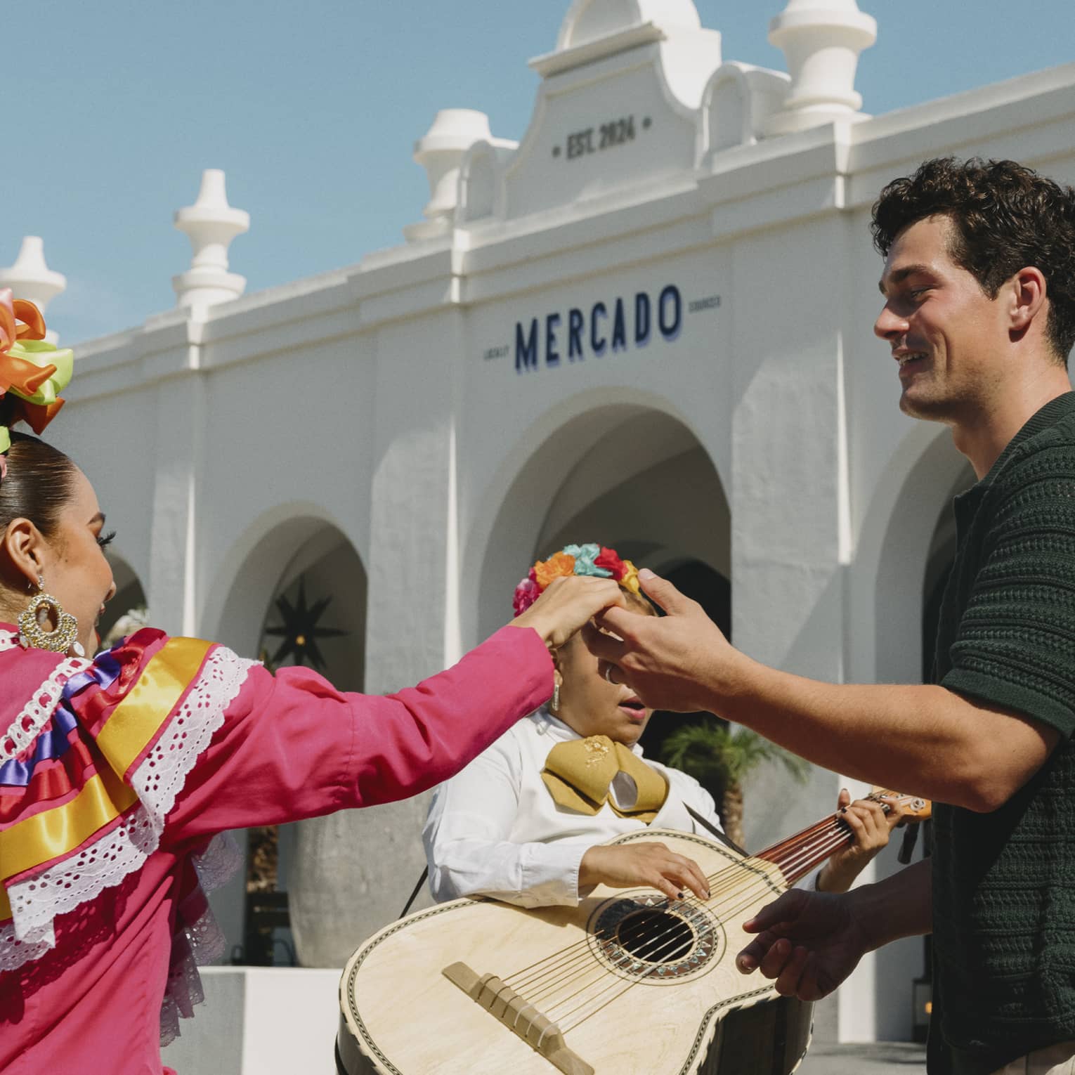 Man and woman dance in front of mariachi band
