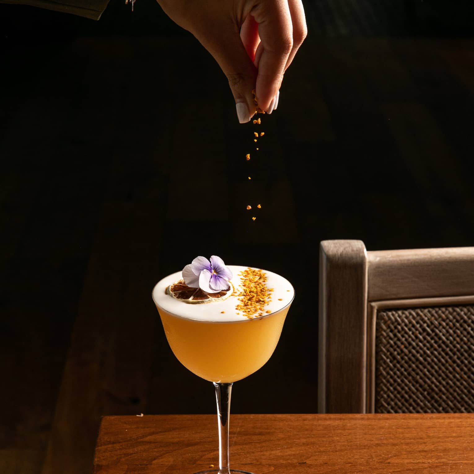 A cocktail being garnished.