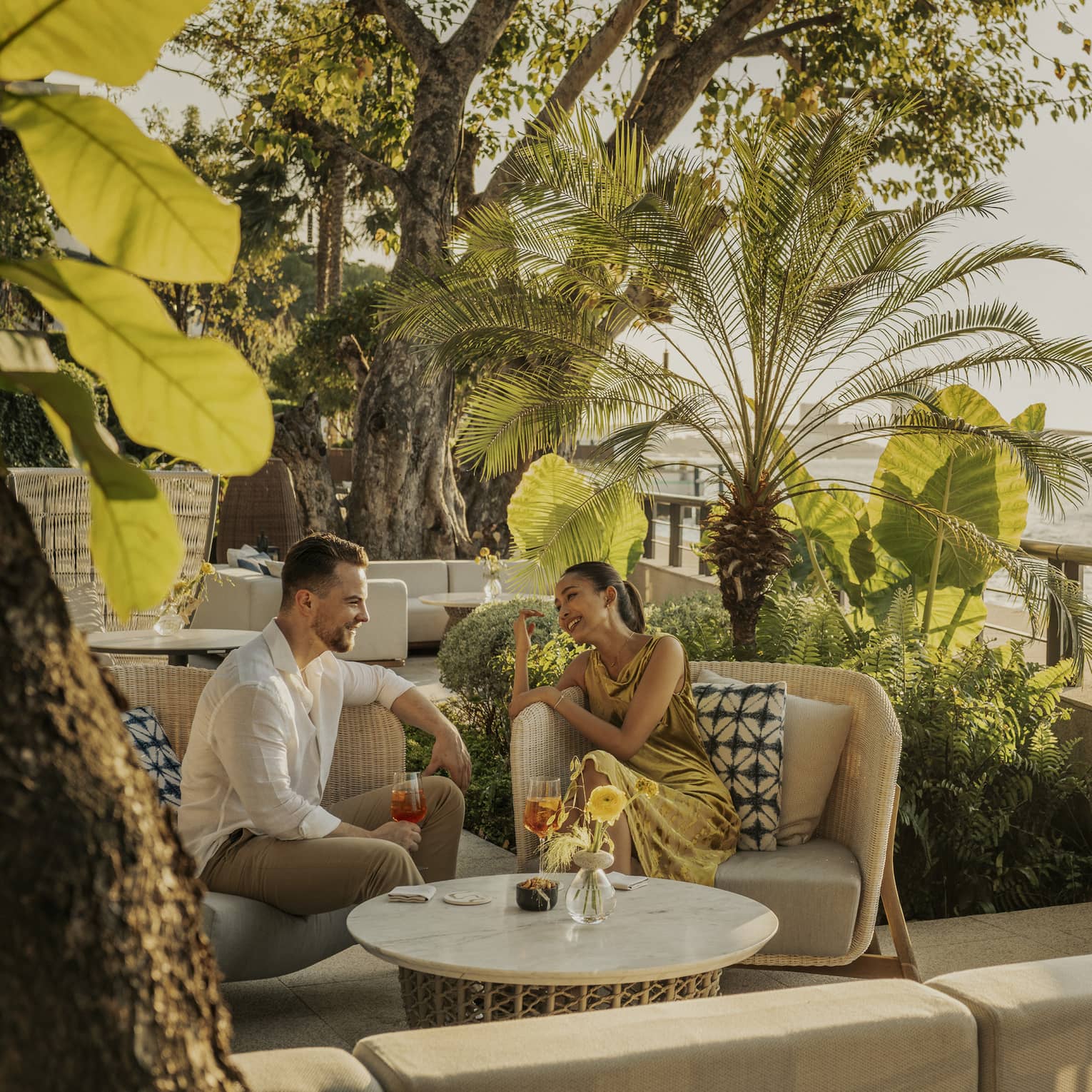Man and woman enjoying a drink in the outdoor lounge