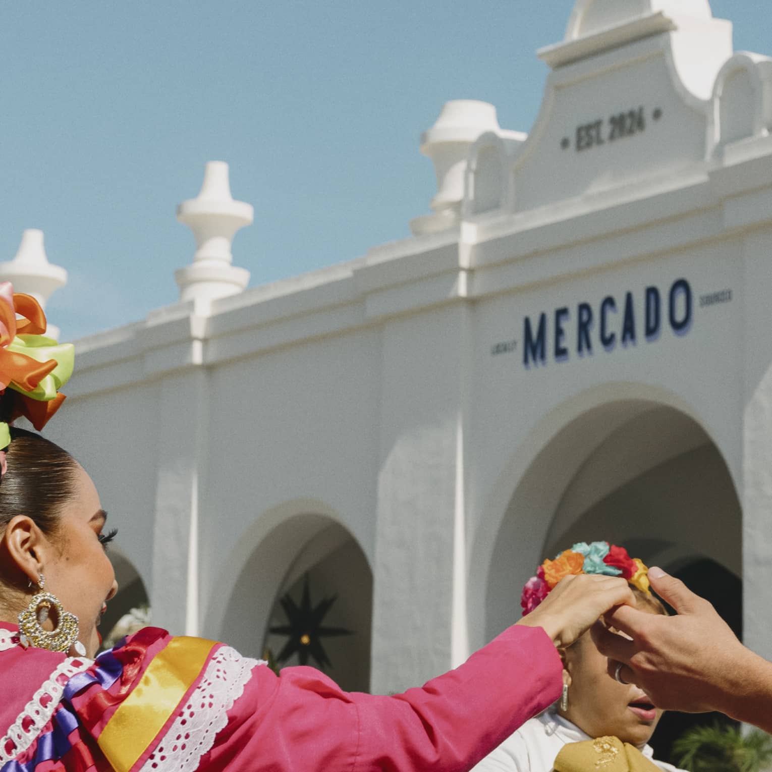 Man and woman dance in front of mariachi band