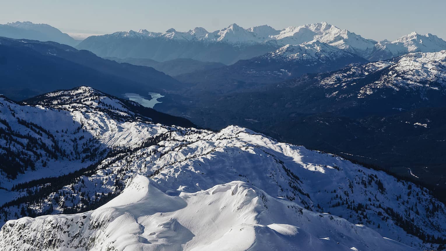 Summit view of snow-covered Coast Mountains