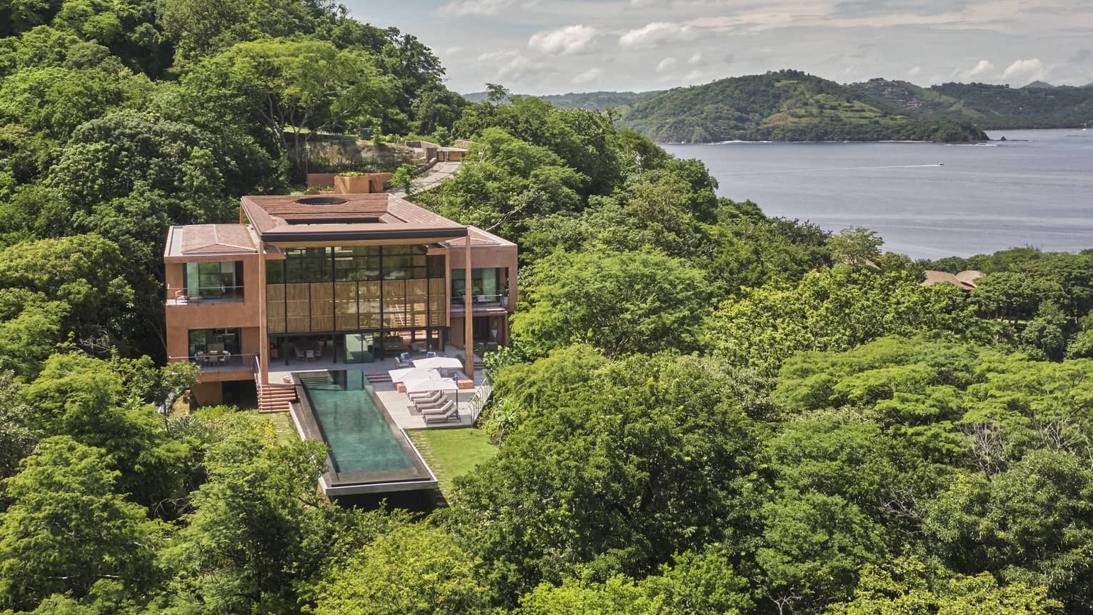 Aerial view of Casa Olas amid greenery and ocean views