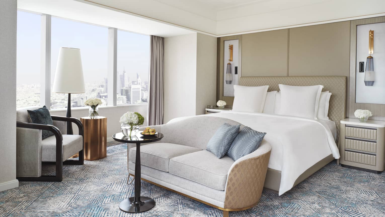 Bedroom with king bed, love seat and arm chair next to window