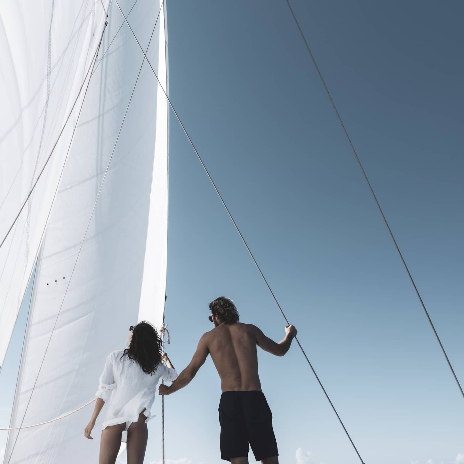 Two people stand on luxury catamaran