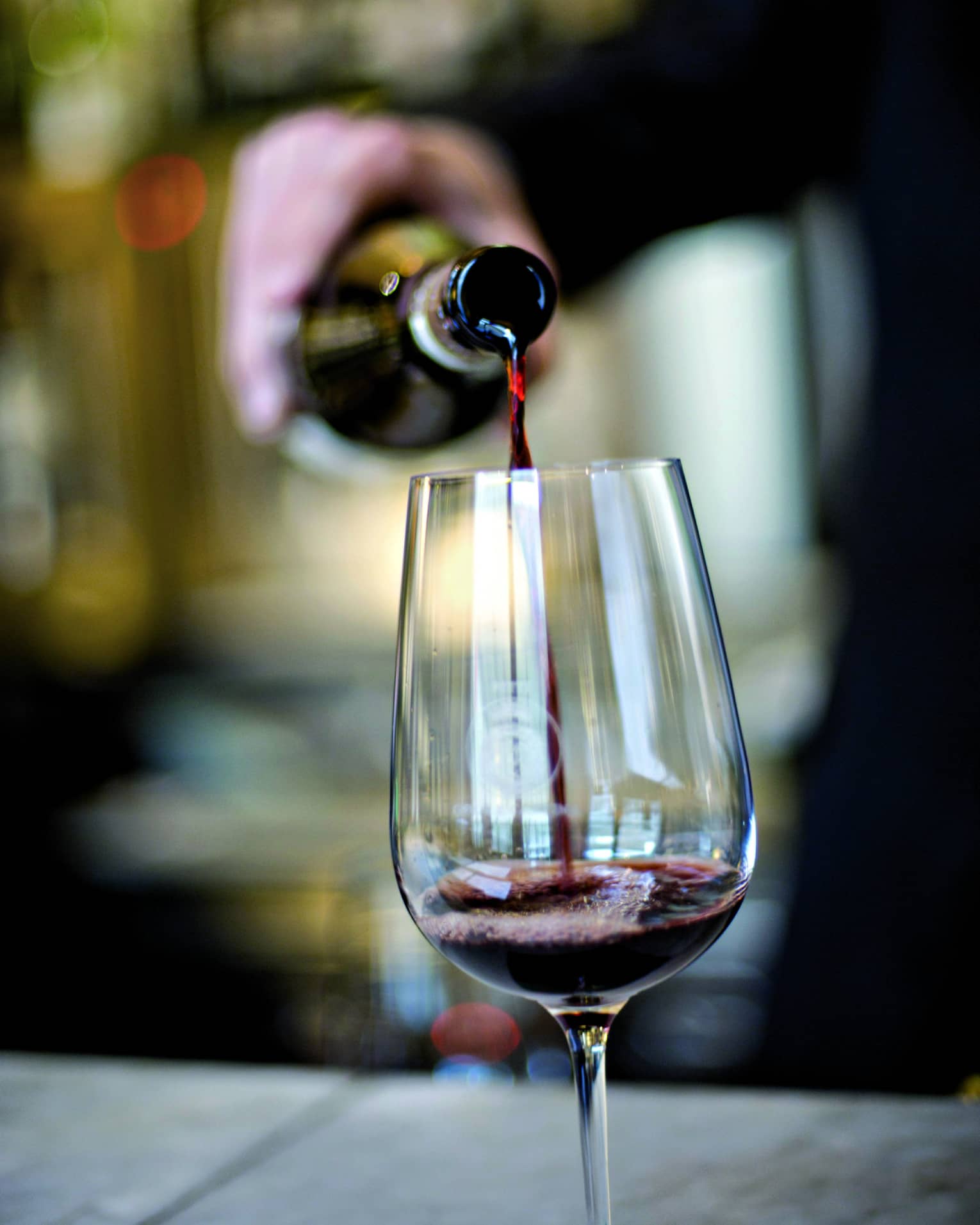 Red wine being poured into a glass.