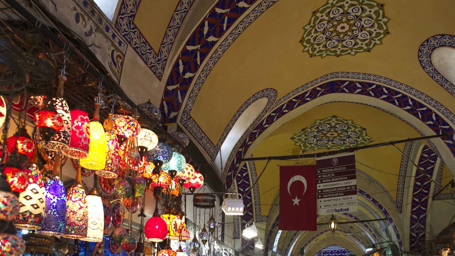 Grand Bazaar Spice Market with wall of colourful Turkish lanterns under mosaic ceiling