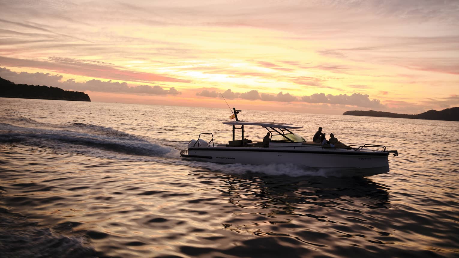 A boat on the water at sunset in island destination